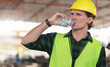 © Poguz.P - Engineer man drinking water at the precast factory site, Worker man drinking water at construction site.