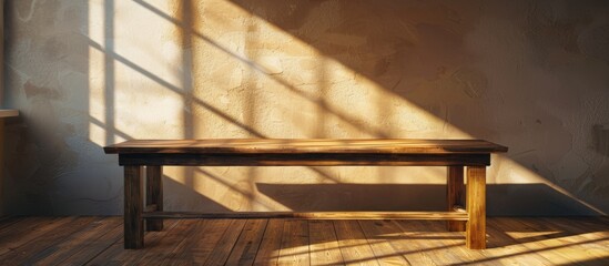 Wall Mural - A wooden table is shown against a wall background under soft window lighting creating subtle shadows in this copy space image