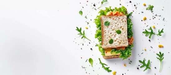 Poster - Top view of a tuna sandwich with cheese lettuce and herbs on a white background ideal for adding text or designs as it provides copy space image