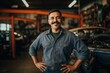 © CojanAI - Smiling portrait of a middle aged car mechanic in workshop