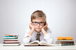 © Anna K@S - Serious Young Boy with Glasses Studying at Desk with Books