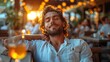 © daniel - A young man enjoys a moment of relaxation while sipping a drink at an outdoor bar, illuminated by soft glowing lights during a sunset