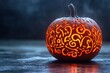 © Viam - Intricately carved glowing pumpkin on dark background