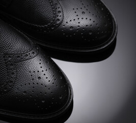 Sticker - Black leather brogue boots on a dark background