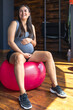 © puhimec - Pregnant sports woman with fit ball in the gym. The concept of sports lifestyle.