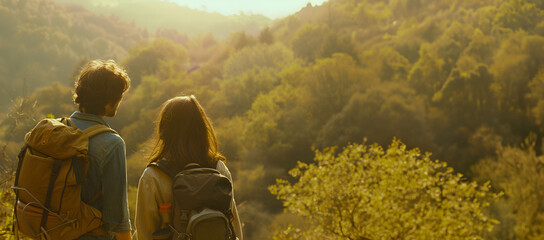 Couple of tourists hiking in the mountains, enjoying a scenic view