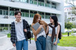 © Wasana - Three young women are walking down a sidewalk, each carrying a backpack