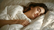 © Aodsy - A woman sleeping soundly in cozy white bedding, enveloped in warmth and comfort, enjoying a peaceful rest.