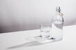© Bidwell Studio - Clear glass water bottle with glass
