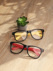 Wall Mural - Stylish fashion eyeglasses on table close up