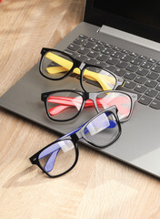 Poster - Laptop with eyeglasses on gray background.