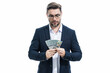 © Volodymyr - Business man hold money on white studio isolated background. Rich man in suit with money dollar bills. Successful businessman with dollar banknotes. Rich millionaire in suit holding money.