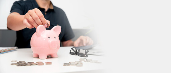 Wall Mural - Man putting coin in piggy bank