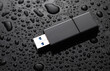 © splitov27 - USB flash drive in drops of water on black background