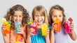 © Sunshine mood - Three young girls enjoying colorful drinks on a summer day.