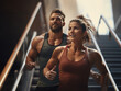 © Llama-World-studio - Male athlete running up stairs with a female workout partner on his shoulders
