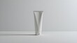© Hashir - Focused view of a single upright white tube on a clean surface, perfect for laboratory or medical settings.