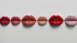 © Yulia - lips in a row with different colors of lipstick on a white background
