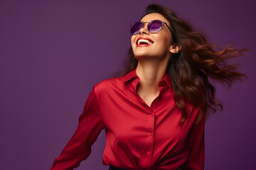 Canvas Print - beautiful woman wearing sun glasses in red shirt enjoying smiling happy over purple background