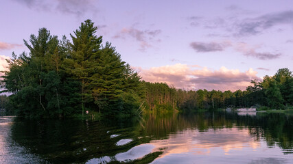 View of Hidden Springs Lake and shoreline lined with woods in Neshkoro, Wisconsin taken on July 5, 2024.