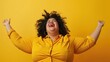 © Johannes - Isolated overweight plus size woman enjoying life on a plain yellow background.
