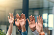 © JordaanExams/peopleimages.com - Group, hands raised and business people with question in office for volunteer, agreement or support. Audience, crowd and vote with staff at workshop for training, feedback or answer orientation query