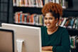 © StarDweller/peopleimages.com - Black woman, computer and face in college library for literature course, research and scholarship opportunity. Student, study and portrait in university for education, learning or writing ebook story
