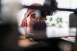 © Studio Marmellata - A woman in a dark red hijab examines the results of a 3D printing project, showcasing her attention to detail and the precision required in handling advanced technology.