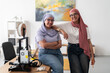 © Studio Marmellata - Two women in hijabs pose confidently in a 3D printing lab, surrounded by equipment and tools. Their stance reflects confidence and pride in their work and achievements in technology.