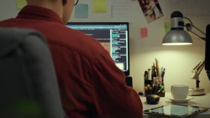 Screen. Experienced specialist using technologies concentrated programming making edits in the evening room. Camera movement home worker corrects program code writes code ai, web development