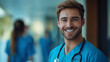© Kootenay - Caucasian White Man Nurse - doctor, smiling, scrubs, male, stethoscope, hospital, healthcare, medical professional, young doctor, friendly doctor, nurse, team, medical team, hallway, medicine, beard