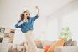 © deagreez - Photo of attractive trendy young woman headphones dancing have fun blue shirt move new apartment home interior indoors