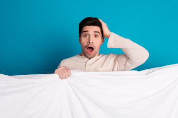 Wall Mural - Photo portrait of nice young male cover blanket amazed scared wear nightwear sleepover good night isolated on blue color background