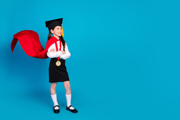 Canvas Print - Full body portrait of little schoolkid uniform mortarboard look empty space isolated on blue color background