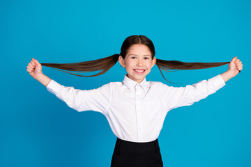 Sticker - Photo of cute small schoolkid hands pull hair wear uniform isolated on blue color background