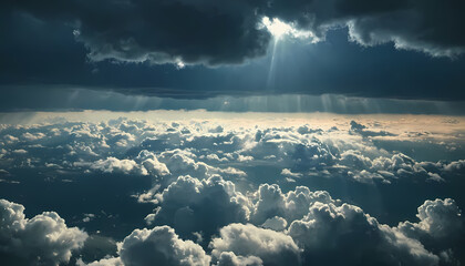 aerial view of dark sky background above rain clouds and sun is peeking out. rainstorm, crepuscular rays, serene nature scene.