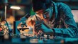 © siriporn - Young Indian Science Student Conducting Electronics Experiment in a University Workshop. Diverse Young Scholar Using Microscope, Working on Connecting a Circuit Board