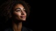 © Matt - Serene portrait of a mixed-race young woman with curly hair, looking upward with a hopeful expression against a dark background,  space for text