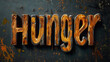 © h3design - The word Hunger is artistically displayed in carved wooden letters with a rich texture against a dark, weathered backdrop