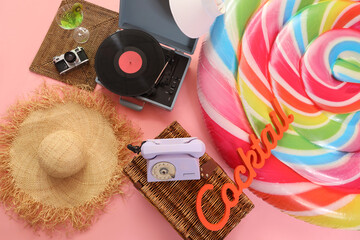 Inflatable mattress, retro phone, hat and record player on orange background. Travel concept