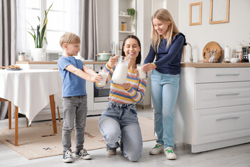 Sticker - Happy family holding glasses with milk in kitchen