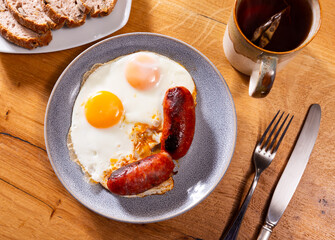 Wall Mural - Appetizing fried egg with chorizo sausage served on platter