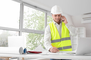 Wall Mural - male contractor with house plan talking by mobile phone in room