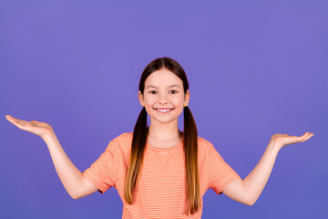 Sticker - Photo portrait of cute little girl compare hold empty space dressed stylish red clothes isolated on violet color background