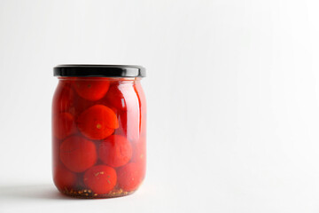 Wall Mural - Tasty pickled tomatoes in jar on light grey background. Space for text