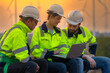 © ultramansk - Team Engineers men and woman checking and inspecting on construction with sunset sky. people operation. Wind turbine for electrical of clean energy and environment. Industrial of sustainable.
