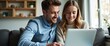 © BOJOShop - Couple Using Laptop Together on Couch.