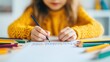 © red_orange_stock - A girl is focused on drawing with colored pencils at home, showcasing her creativity and artistic skills