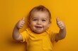 © INFAYUFA - Cheerful Baby in Yellow Giving Double Thumbs Up
