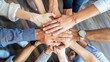 © Naknakhone - The top-view of diverse people nationalities fold their hands together on each other, symbolizing their unity and support. A team of people who are set up for productive work and a positive result.